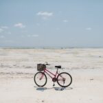 pexels-photo-7293099 bicycle parked on vast sandy shore of endless sea