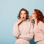 shocked-ladies-sharing-rumors-studio-shot-amazed-gossip-girls-posing-blue-background oversharing