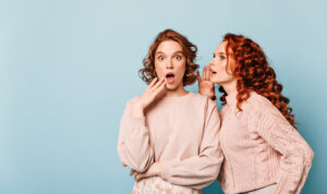 shocked-ladies-sharing-rumors-studio-shot-amazed-gossip-girls-posing-blue-background oversharing