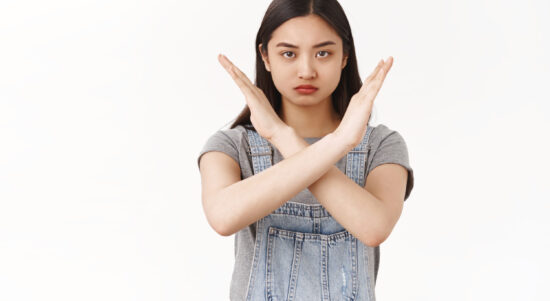 waist-up-serious-looking-confident-determined-asian-brunette-woman-demanding-stop-show-cross-arms-frowning-sulking-warn-give-strong-refusal-decline-hideous-offer-prohibiting-taboo-white-wall