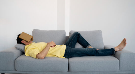 full-shot-man-laying-couch-with-book