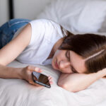 sleepy-blogger-bed-using-her-smartphone