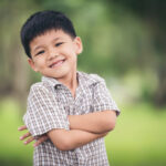 portrait-cute-little-boy-standing-with-arms-folded-looking-camera