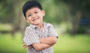 portrait-cute-little-boy-standing-with-arms-folded-looking-camera