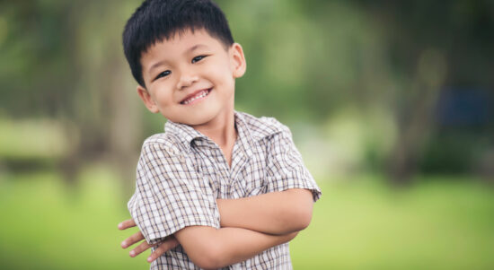 portrait-cute-little-boy-standing-with-arms-folded-looking-camera